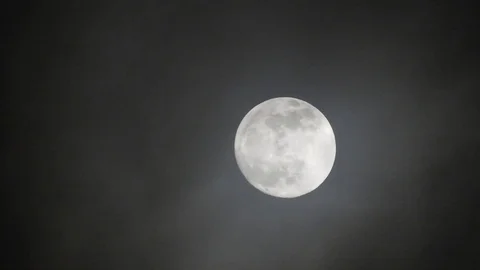 Full moon on dark cloudy night. Clouds passing by the moon, real time shot. Video stock 122694488