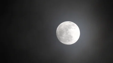 Full moon on dark cloudy night. Clouds passing by the moon, real time shot. Video stock 122694576