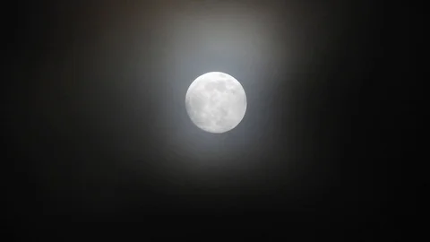 Full moon on dark cloudy night. Clouds passing by the moon, real time shot. Video stock 122695024