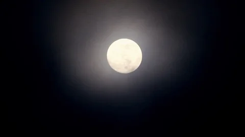 Full moon on dark cloudy night. Clouds passing by the moon, real time shot. Video stock 122695035