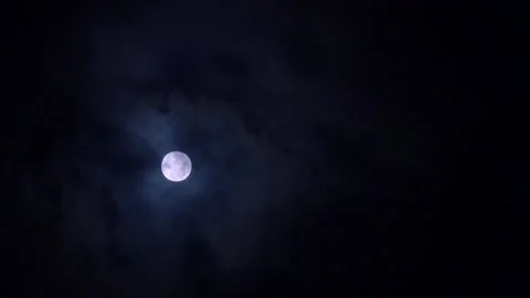 Full moon on a dark cloudy night. Mystical clouds float past the moon Stock Footage 254417956