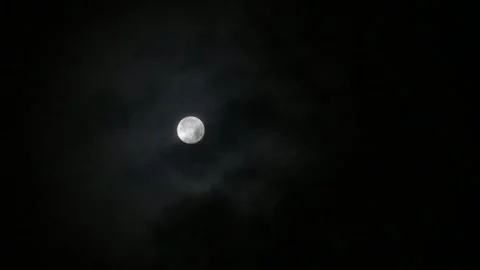Full moon on a dark cloudy night. Mystical clouds float past the moon Stock Footage 254417999
