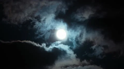 Full moon on dark cloudy sky. Cumulus clouds passing by bright moon Stock Footage 194485937