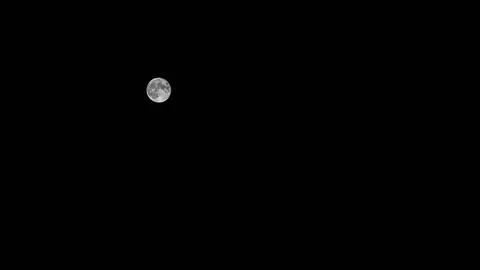 The full moon in the dark sky illuminates the earth Stock Photos