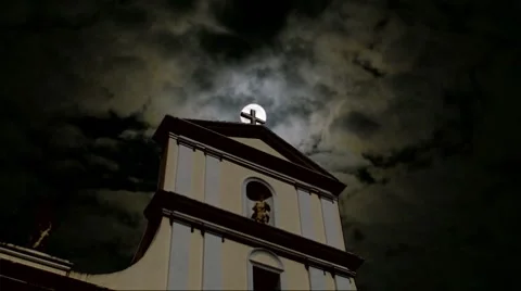 Full Moon Dramatic Scary Clouds behind Spooky Catholic Cathedral Cross Stock Footage 8549134