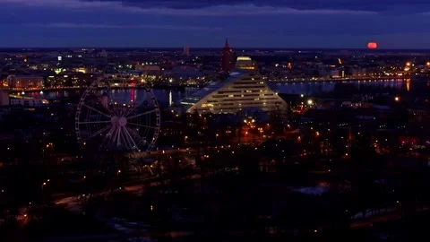 Full Moon Eclipse Over Riga Latvia with Ferris Wheel and National Library at Stock Footage 310178790