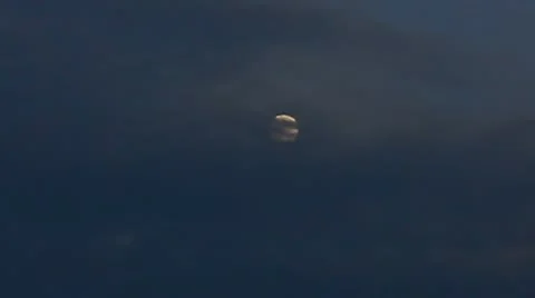 Full moon emerging from behind clouds Video stock 10891597