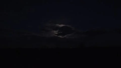 Full moon glowing behind drifting clouds across dark night sky - Moving Clouds Vídeo Stock 339339752
