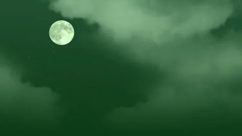 Full moon glowing brightly while drifting through dark swirling clouds with Stock Footage 340940529