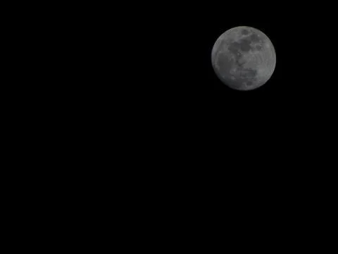 Full moon glowing in dark night sky Stock Photos