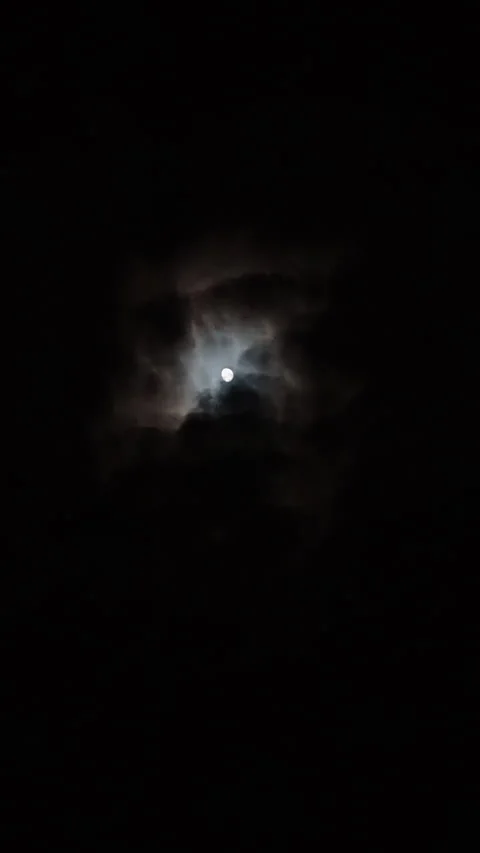 Full moon glowing through dramatic night clouds in dark vertical sky video 스톡 동영상 313538070