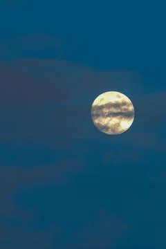 Full moon hiding behind the clouds. Stock Photos