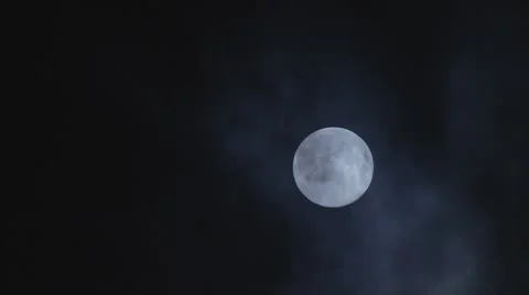 Full moon hiding by the clouds on dark mist night sky background - long shot Stock Footage 8836566