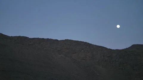 Full Moon Hovering Above Dark Rocky Desert Ridge Stock Footage 336025480