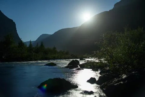 The full moon illuminates the mountain river. Night landscape Stock Photos