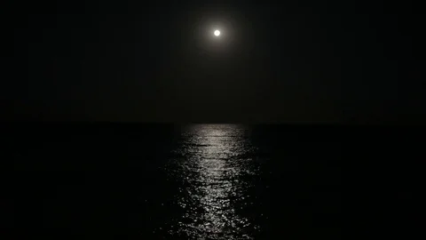The full moon illuminates the water surface. Moon track on the surface of the Stock Footage 119953333