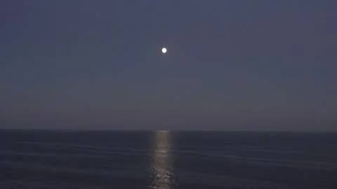 The full moon illuminates water surface. Moon track on surface water. Stock Footage 139747914
