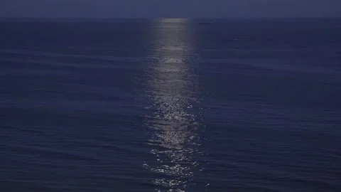 The full moon illuminates water surface. Moon track on surface water. Stock Footage 139747971