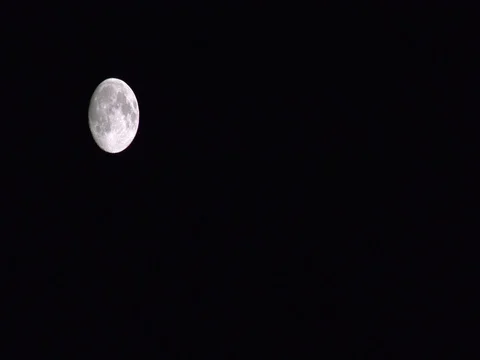 Full moon moves in the black sky and runs through the screen Stock Footage 78531357