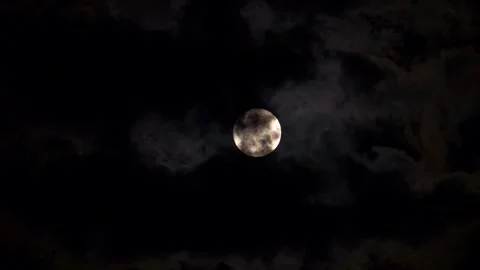 The full moon moving quickly and floating among the clouds in the night sky, Stock Footage 282897528