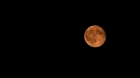 Full moon moving slowly through the night sky against a black background Stock-Footage 345828715