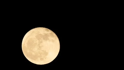 A full moon moving through frame in a time lapse. Stock Footage 99059914