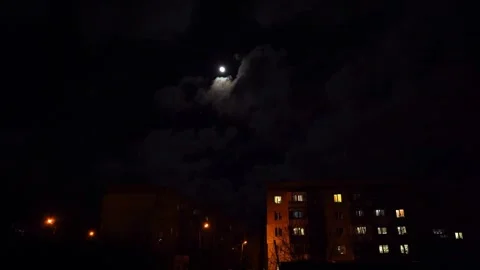 Full moon in the night sky above high-rise buildings illuminated by lanterns Stock Footage 296597292