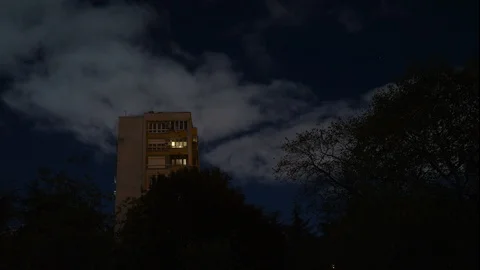 Full moon, night, soaring clouds on the background of a multistory building Stock Footage 117974604