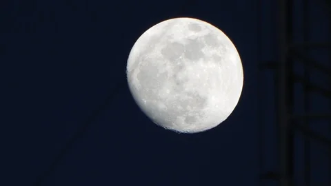 Full moon at night, timelapse passing behind an antenna / communications mast. Stock Footage 95699621