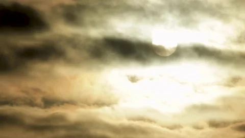 Full Moon or Sun moving behind beautiful clouds in dark black sky. Stock Footage 221293606