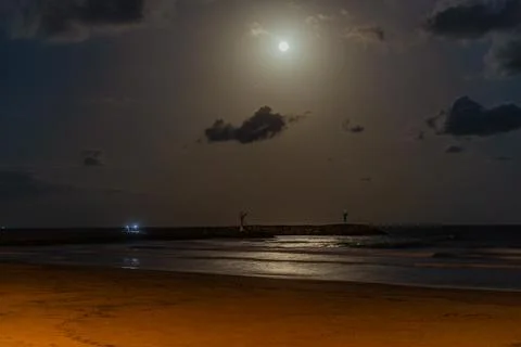 Full Moon Over Calm Nighttime Beach Waters Stock Photos