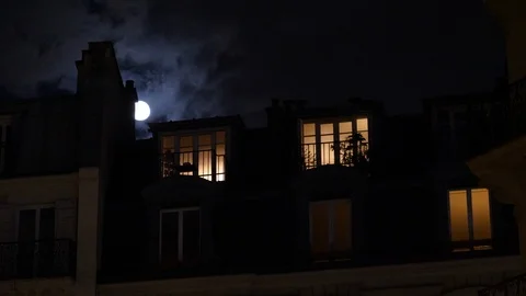 Full moon over Champs Elysees Paris France building mansard roof Stock Footage 105815576