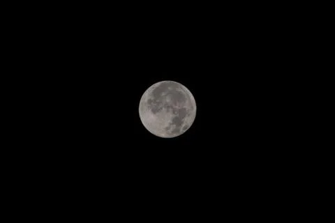 Full moon over dark black sky at night Stock Photos