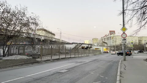 Full moon over the evening city. Moving cars Stock Footage 174253483