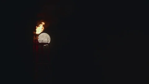 Full Moon over the gas flaring on the rig Stock Footage 84053936