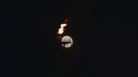 Full Moon over the gas flaring on the rig Stock Footage 84054310