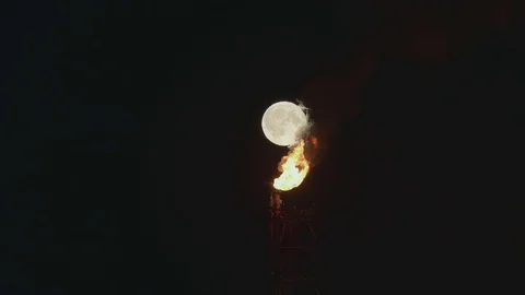 Full Moon over the gas flaring on the rig Stock Footage 84055668