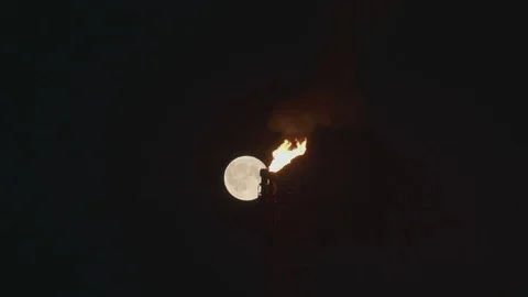 Full Moon over the gas flaring on the rig Stock Footage 84056452