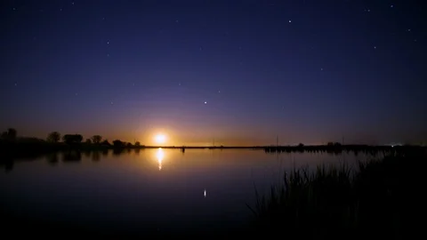 Full Moon Over Lake Time Interval. A starry night sky. Stockbeeldmateriaal 91407707
