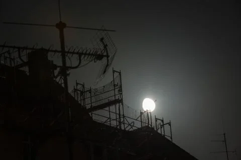 Full moon over the roofs Stock Photos