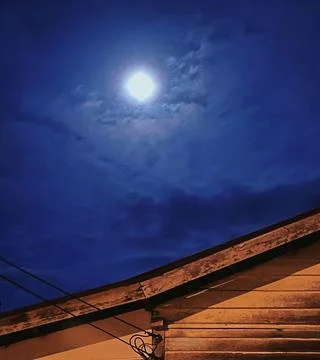 Full Moon Over Rooftop Stock Photos
