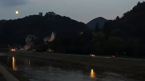 Full moon over the scenic Celje river embankment promenade with evening tra.. Stock Footage 341678397