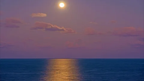 Full moon over sea at colourful sunset on a tropical island. 4k time-lapse Stock Footage