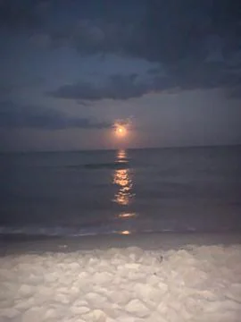 Full Moon Over the Sea with Reflection at Night Stock Photos