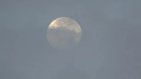 Full Moon Partially Obscured By Thin Clouds During Daylight Stock Footage
