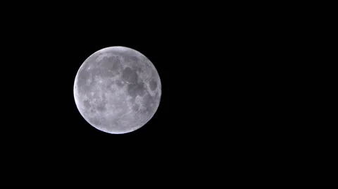 A full moon passes across the frame, shrouded by fast-moving clouds Video stock 43443223
