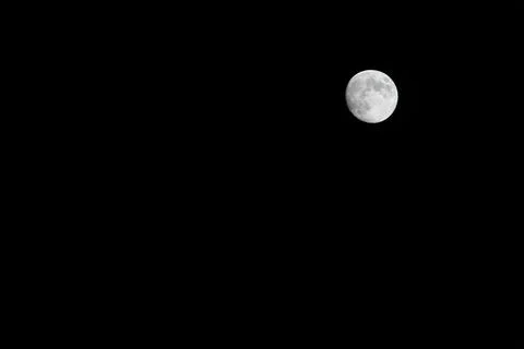 Full Moon on the Right Side Against a Black Night Sky in Spain 库存照片