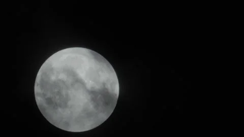 Full moon rises behind the clouds Stock Footage 168769195