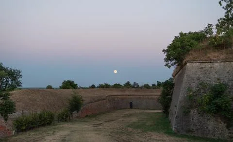 Full moon rises over the historical fortifications of Petrovaradin Fortress Stock Photos