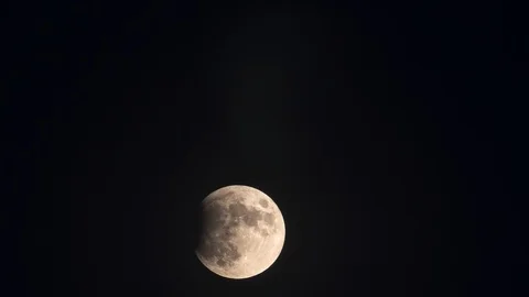 Full Moon rises in the Sky. Initial phase of an Eclipse. Time Lapse Stock Footage 124102081